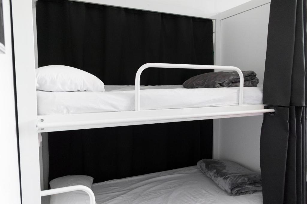 two bunk beds in a room with black walls at Kabul Party Hostel Barcelona in Barcelona