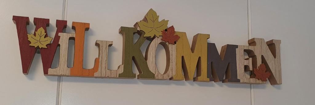 a sign that reads autumn hanging on a wall at Ferienwohnung da Celia in Berchtesgaden
