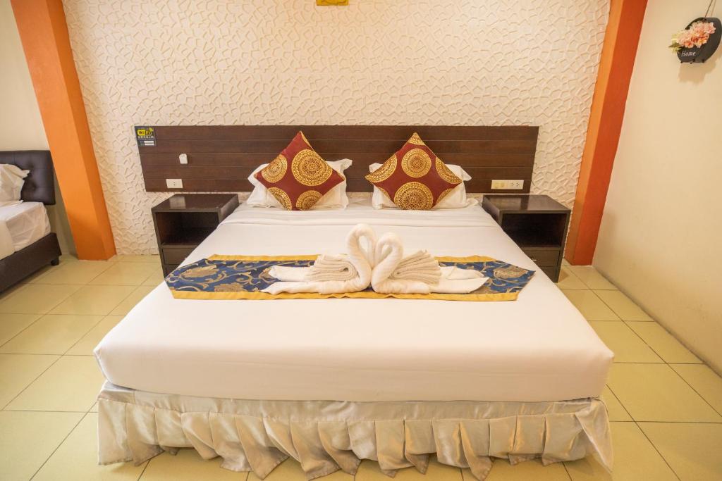 Postel nebo postele na pokoji v ubytování Lily Holiday hotel 百合假日酒店