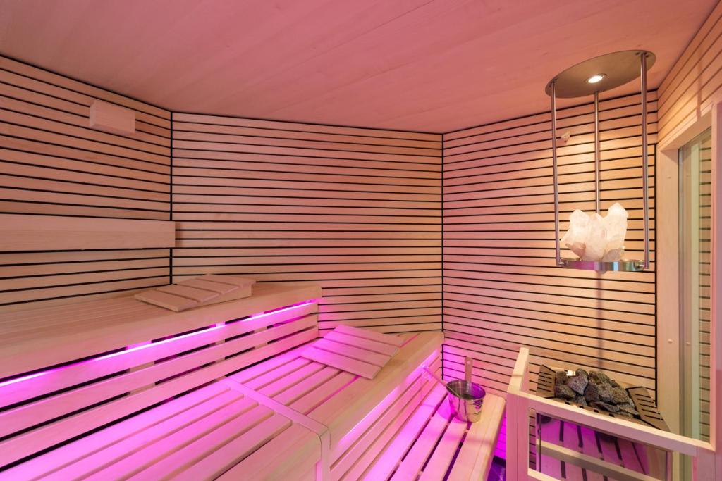 a room with a sauna with pink lighting at Hotel Haus Tiefenbach in Bullange