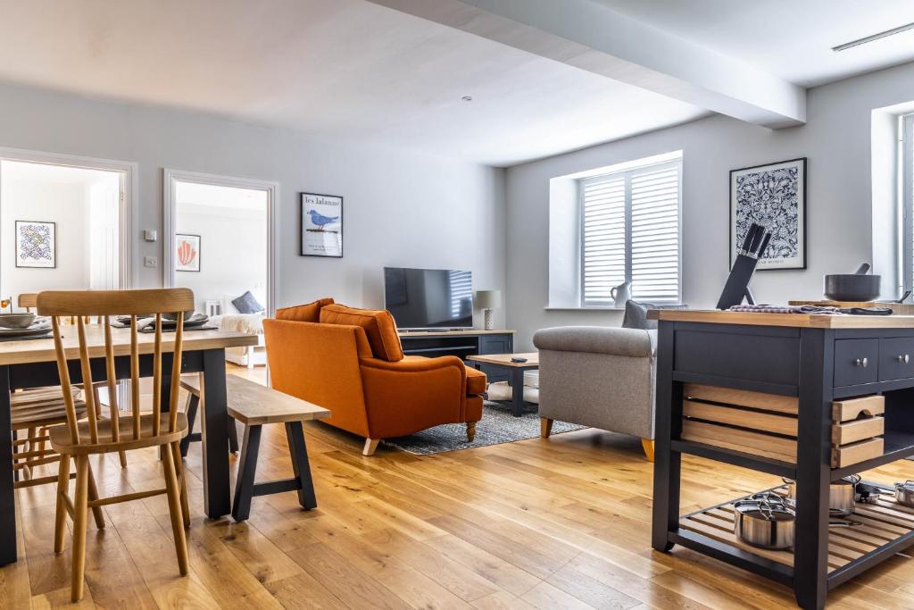 a living room with a table and chairs at The Unicorn (Apartments) in Stow on the Wold