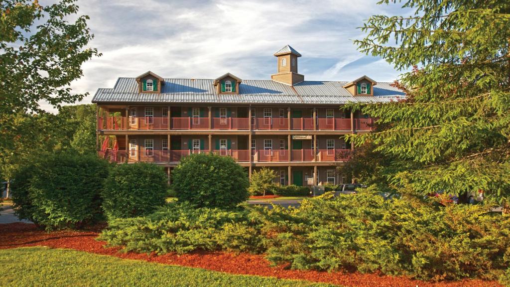 a large building with a clock tower on top of it at Holiday Inn Club Vacations Oak n Spruce Resort in the Berkshires an IHG Hotel in South Lee