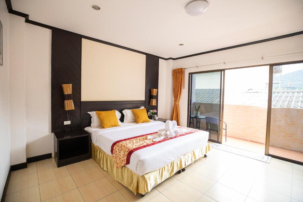 Postel nebo postele na pokoji v ubytování Lily Holiday hotel 百合假日酒店