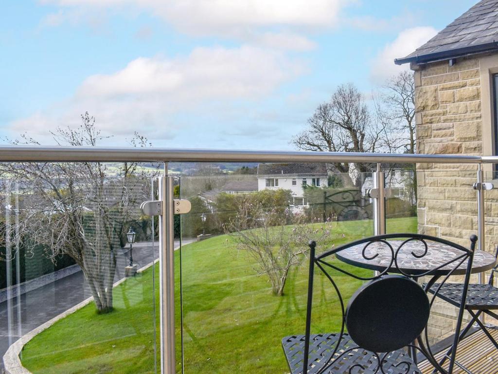 a balcony with a view of a yard at Kinneret Apartment in Silsden