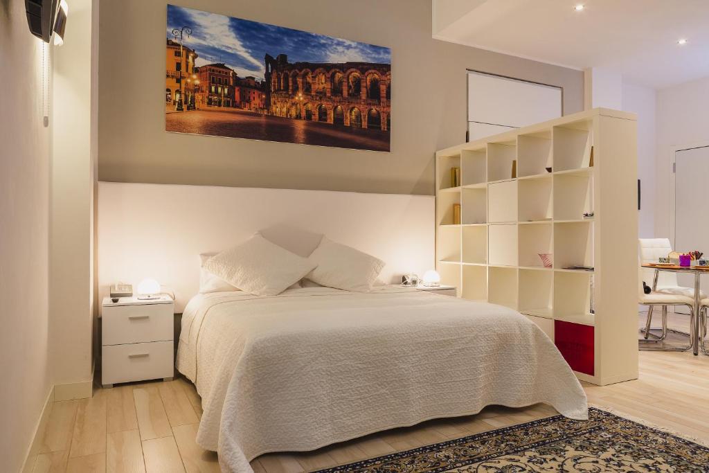 a bedroom with a bed and a book shelf at San Nicolò 3 in Verona