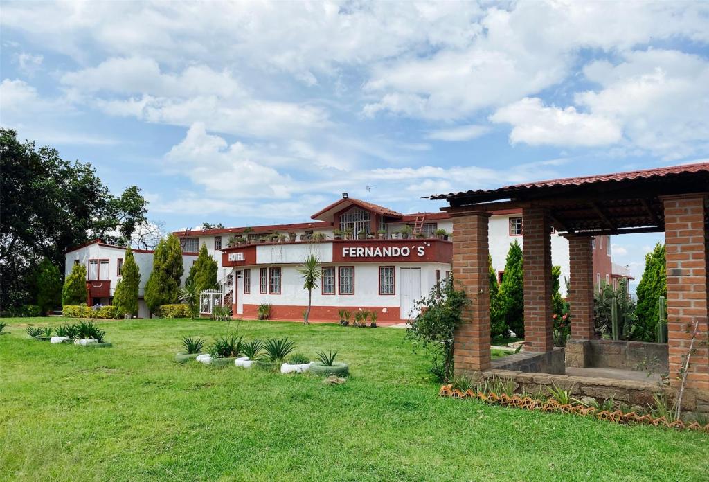 a building with a lawn in front of it at Hotel Fernando´s in Tlalpujahua de Rayón