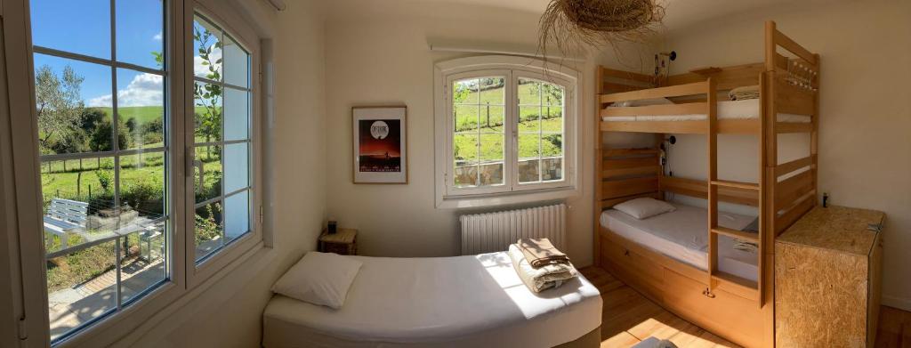 a small room with a bunk bed and a window at Amama Baita in Urrugne