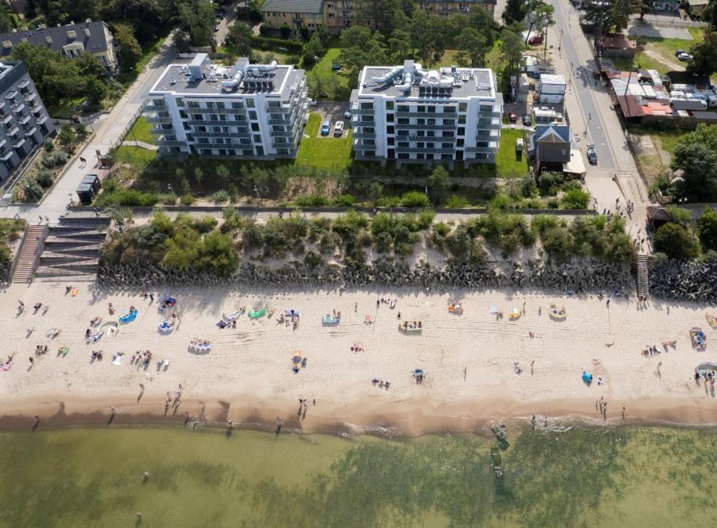 an aerial view of a beach with people on it at Jantaris B1 - Apartament 20m od plaży in Mielno