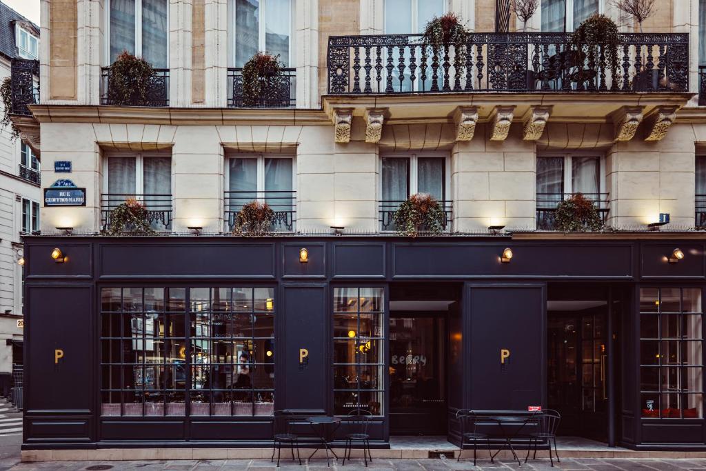 a black building with chairs in front of it at Hotel Panache in Paris