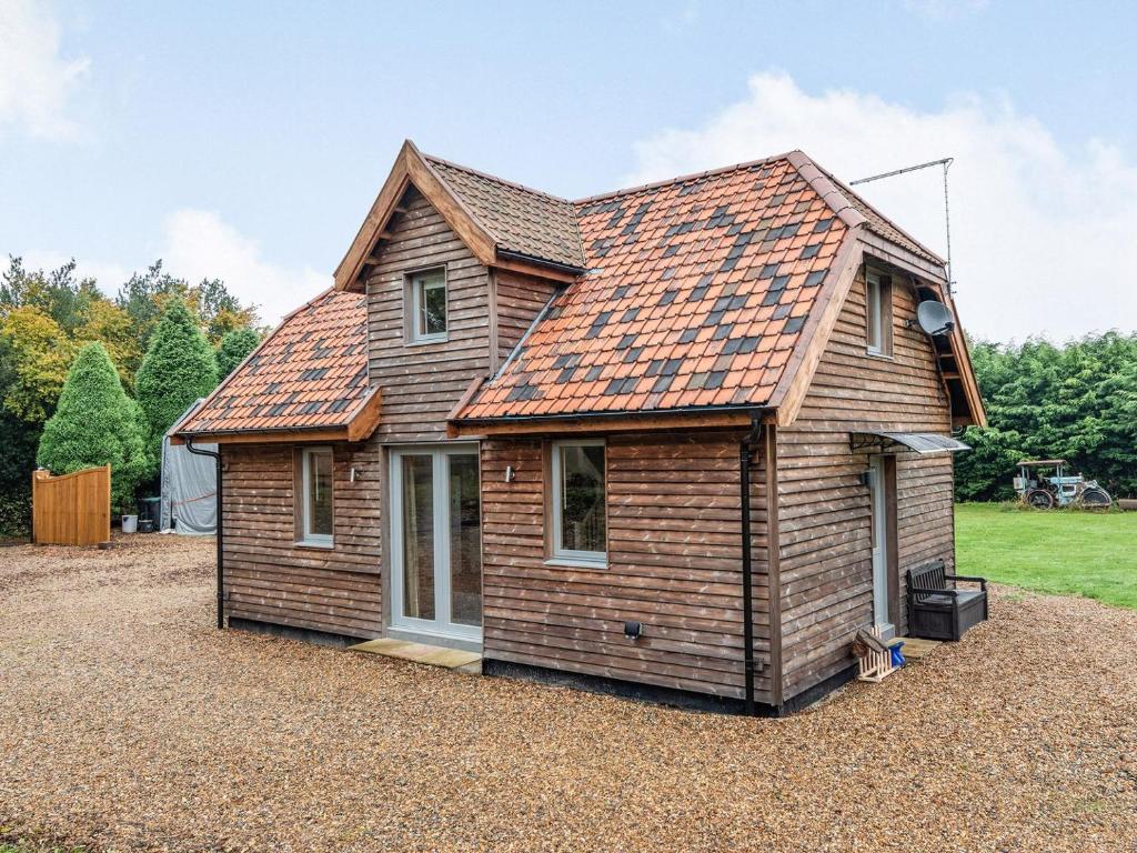 a house with an orange roof on a gravel yard at Brindleshaw Barn in Meopham