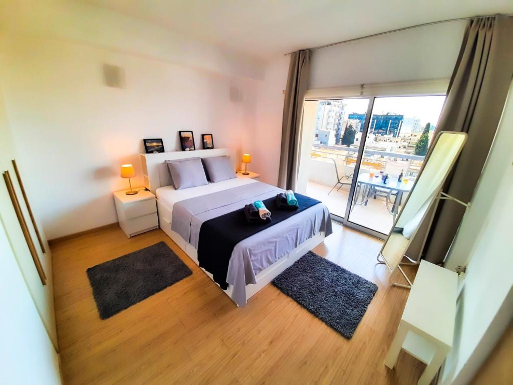 a bedroom with a large bed and a large window at Eden Sea Breeze, 1 bed, Rooftop Pool, Gym in Limassol