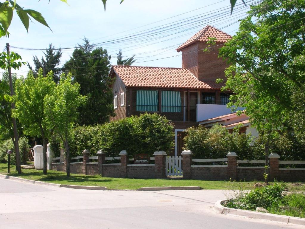 una casa con una valla delante de ella en La Soleada en Mina Clavero