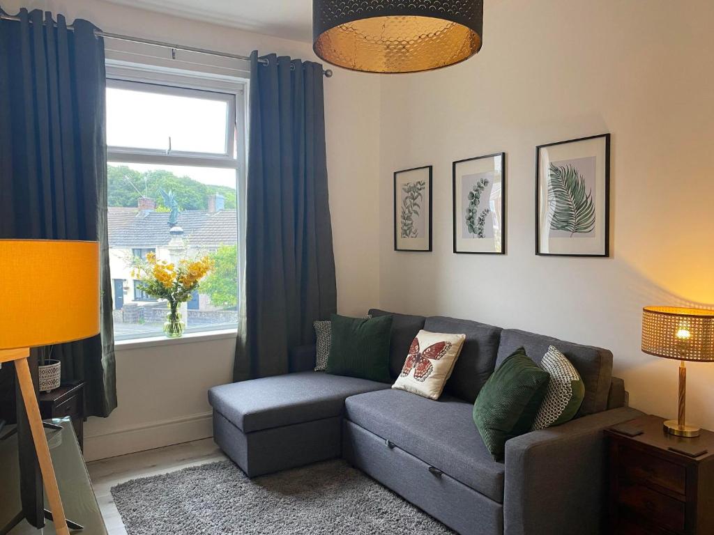 a living room with a couch and a window at The Retreats 1 Kenfig Hill Pet Friendly 2 Bedroom Flat with King Size bed twin beds and sofa bed sleeps up to 5 people in Kenfig Hill