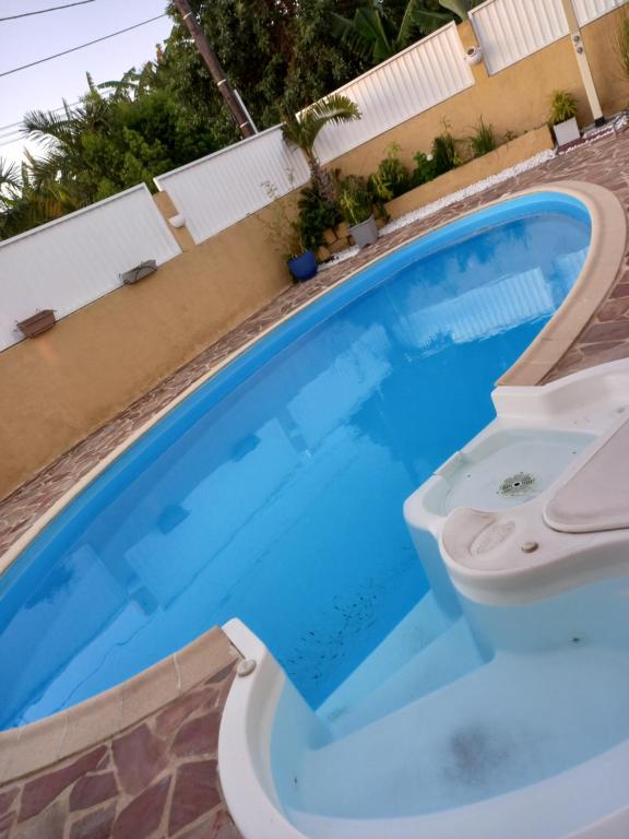 a blue swimming pool with a toilet in it at FREDERIC FRANCOIS in Le Tampon