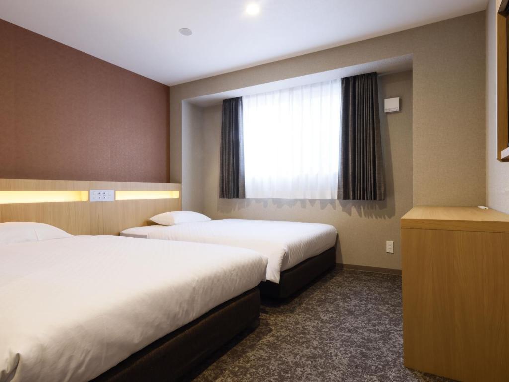 Postel nebo postele na pokoji v ubytování Plum Hotel