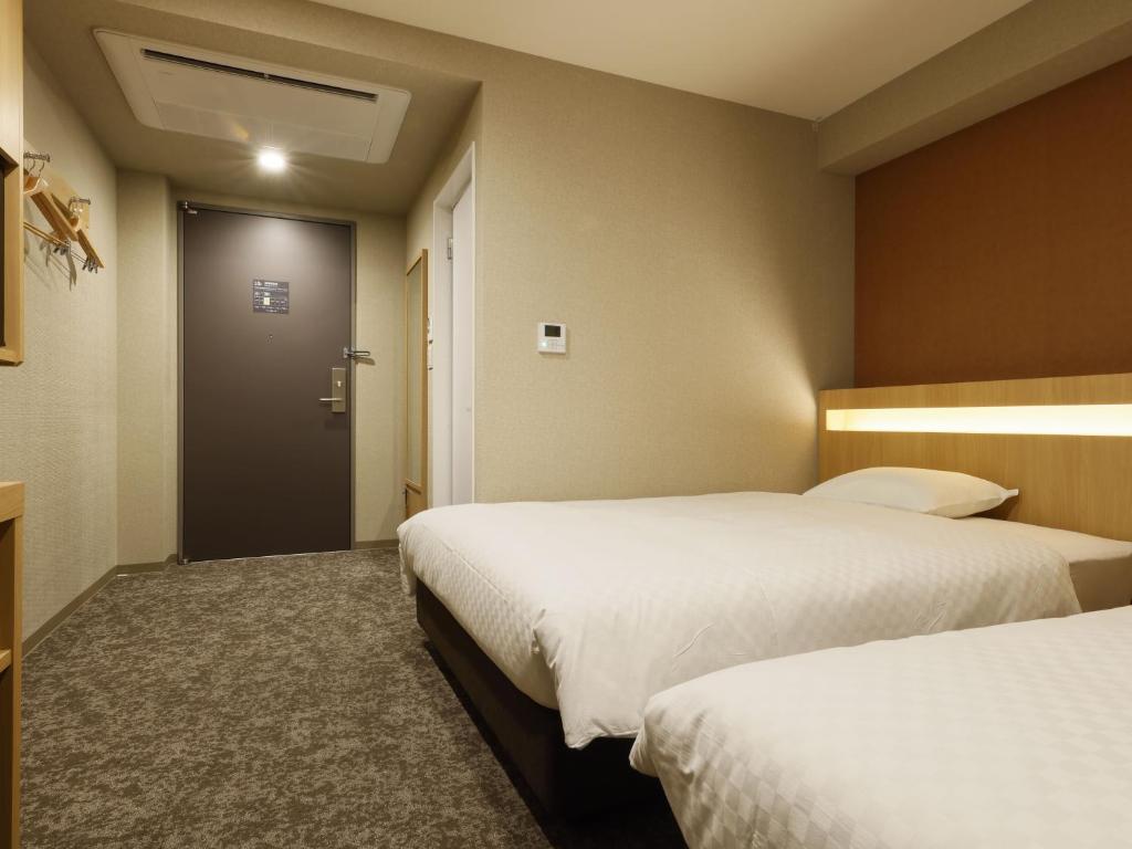 Postel nebo postele na pokoji v ubytování Plum Hotel