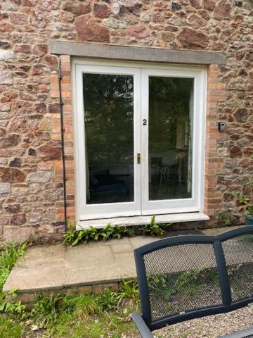 a window in a brick building with a chair in front of it at The Grange in Bristol