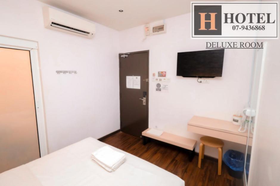 Postel nebo postele na pokoji v ubytování H Hotel