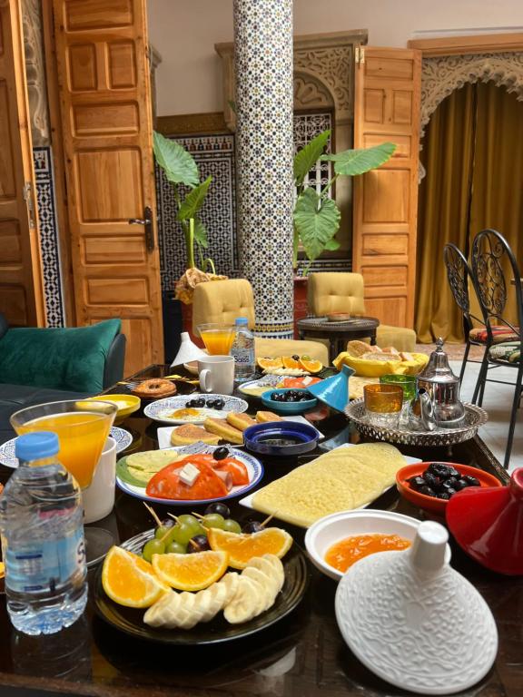 a table topped with lots of different types of food at Riad Majorelle in Rabat
