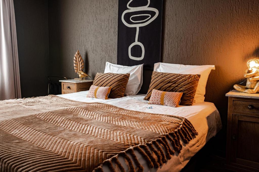 a bedroom with a large bed with a large comforter at Hotel La Casa in Valkenburg