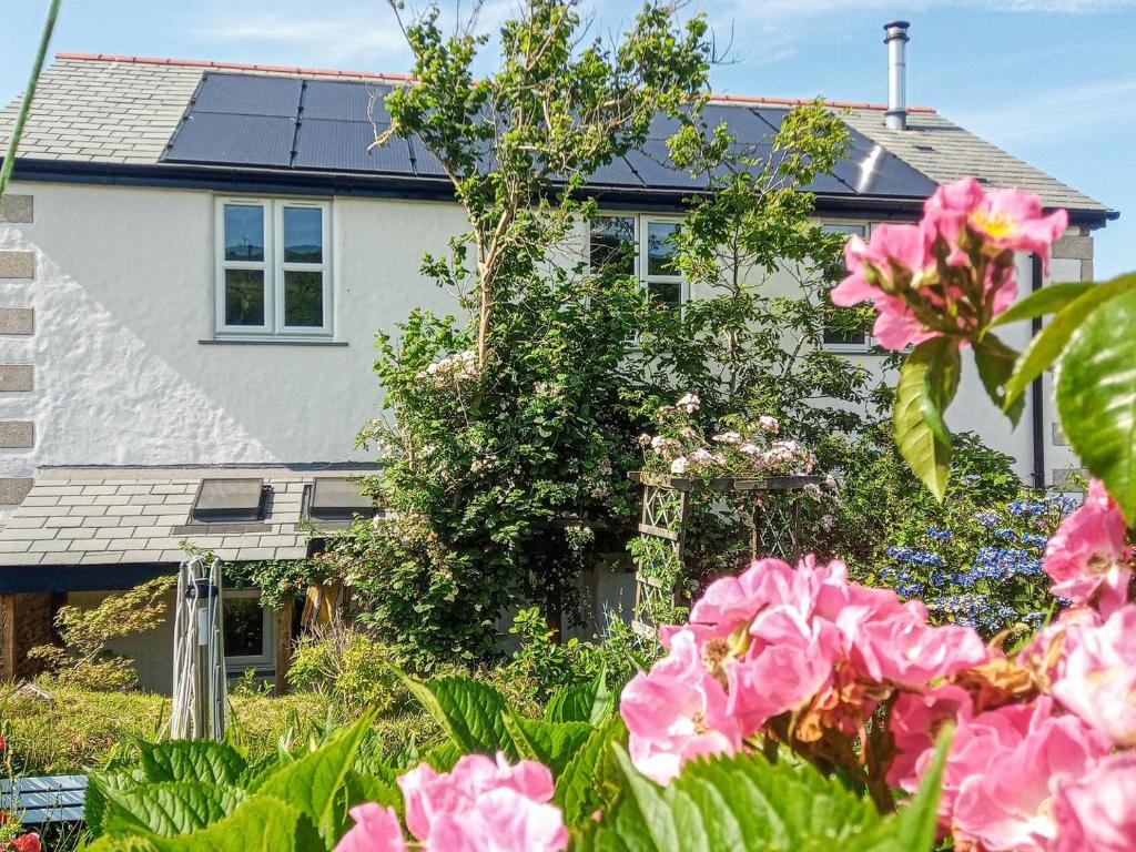 a house with pink flowers in front of it at Elderberry Cottage in Carnbrea