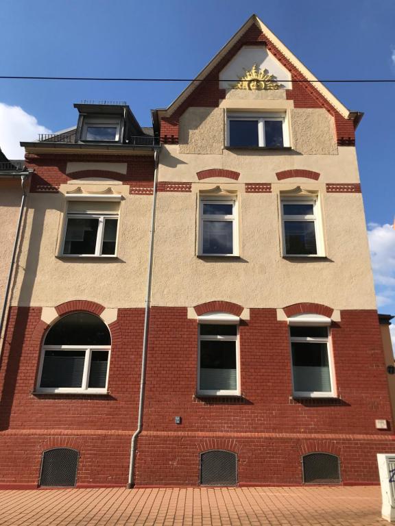 a red brick building with a clock on it at APARTMENT SONNE Reusa in Plauen
