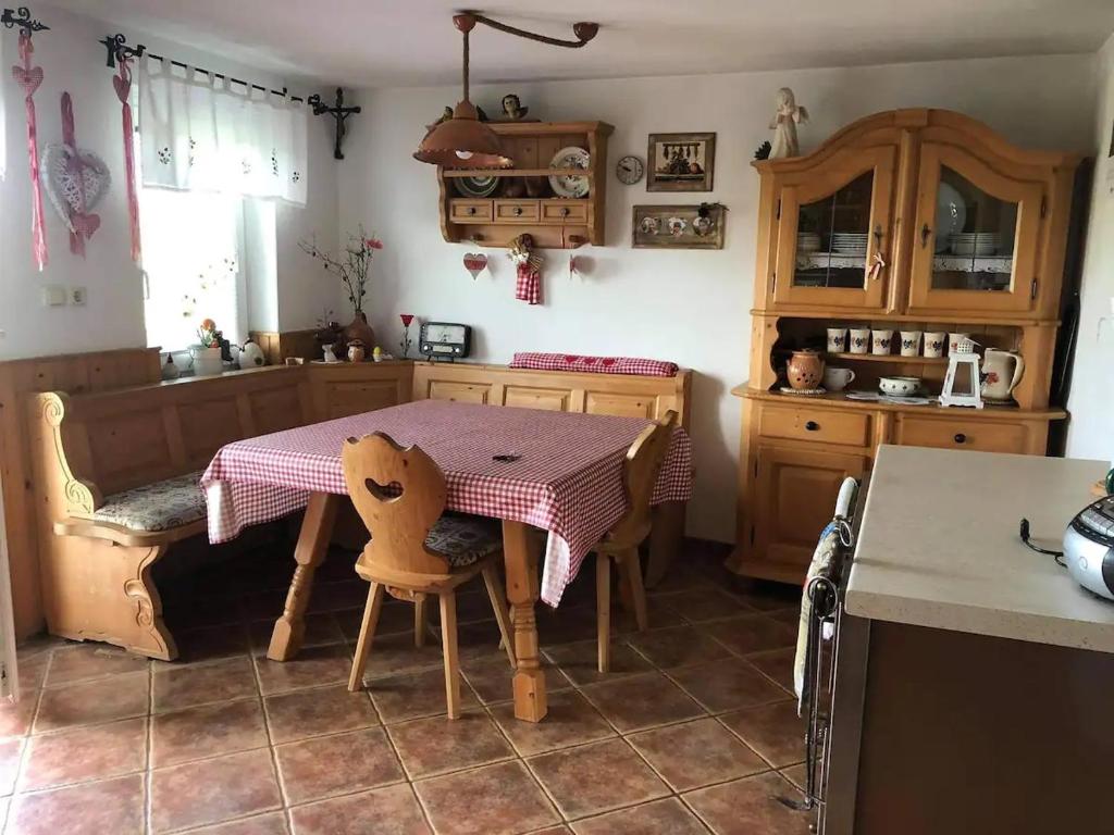 a kitchen with a table and a table and chairs at Cosy country home, Lendava in Lendava