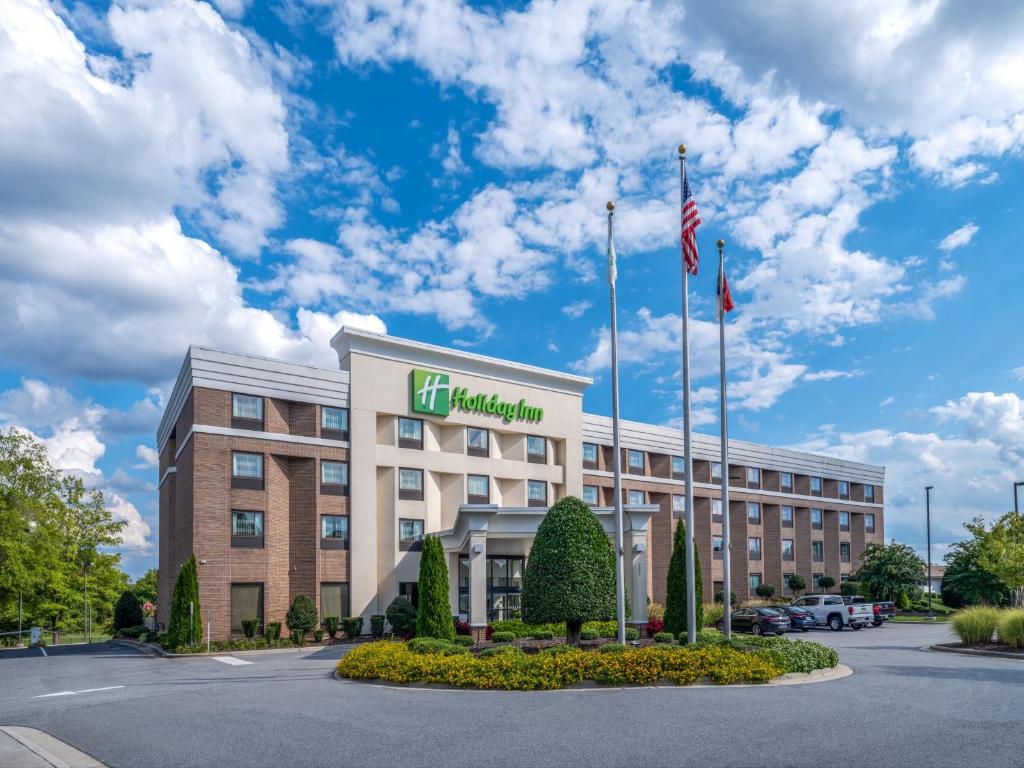 an image of a hotel with a building at Holiday Inn Greensboro Coliseum, an IHG Hotel in Greensboro