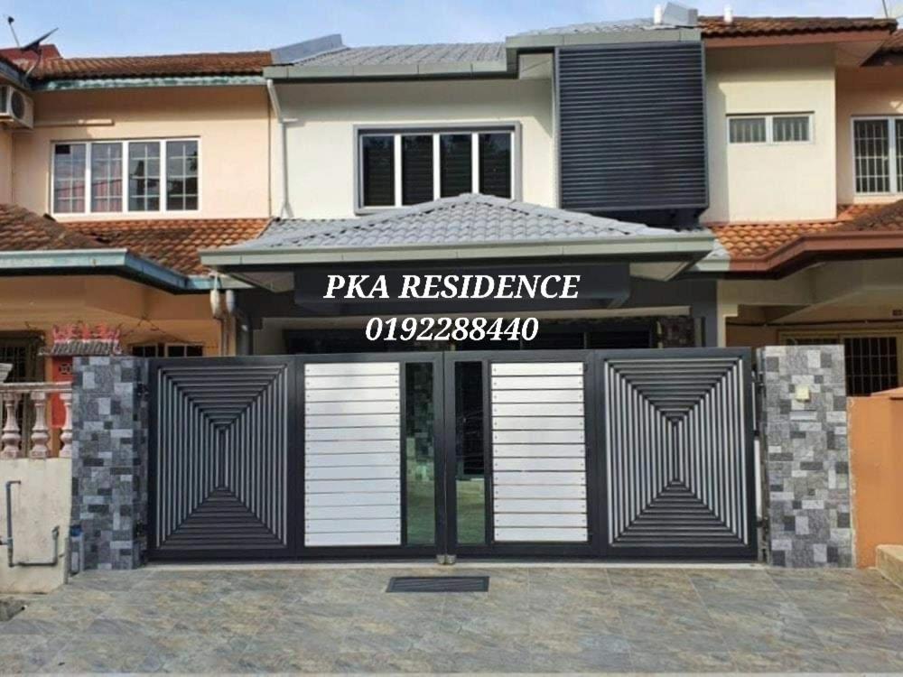 a pizza residence with a gate in front of a house at PKA Residence at Taman Bentong Makmur in Bentong