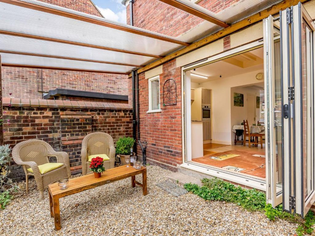 an extension to a brick house with a patio at Top Studio-uk35143 in Lincoln