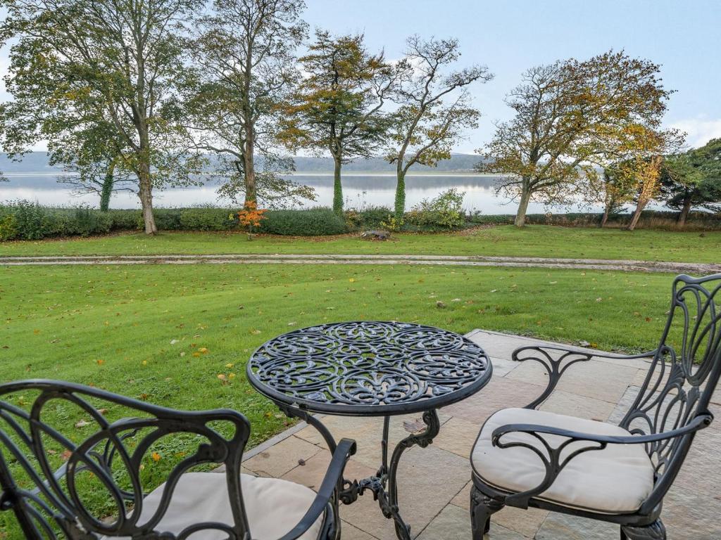 a table and two chairs and a table and a table and chairs at Arnside View in Arnside