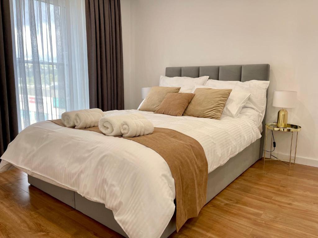 a large bed with two pillows on it in a bedroom at Apartamenty Centrum Apartament X1 in Mszana Dolna