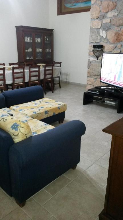 a living room with two blue couches and a piano at B&B Manzoni Resort in Brindisi