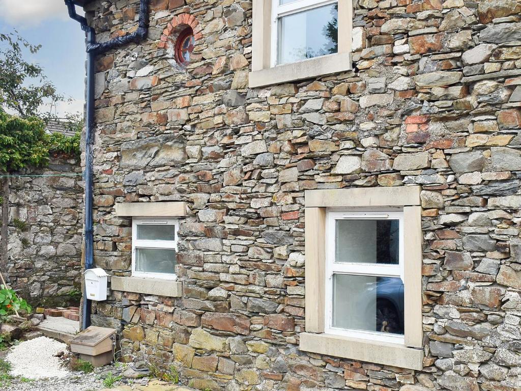 a stone building with three windows on it at Barn 2 in Ulverston