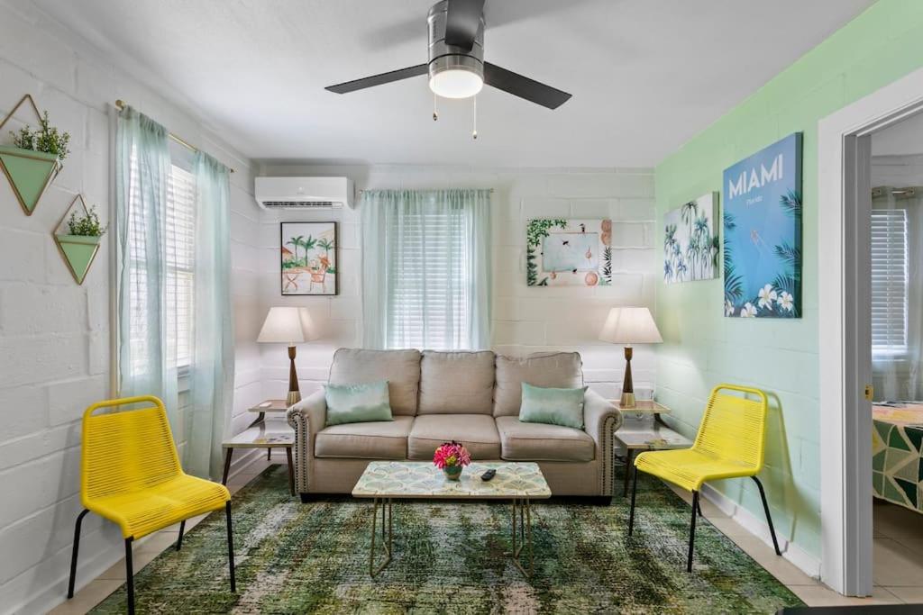 a living room with a couch and two yellow chairs at Deco Drive WATERFRONT 1Bed Apartment on the Bay in Tampa