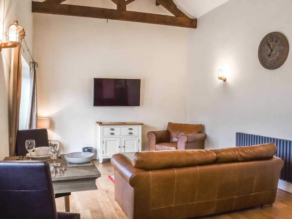 a living room with a couch and a table at Swallow Barn in Hargrave