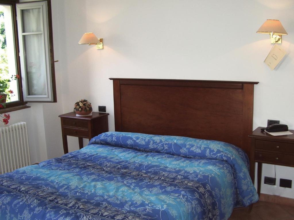 Postel nebo postele na pokoji v ubytování Hotel La Locanda