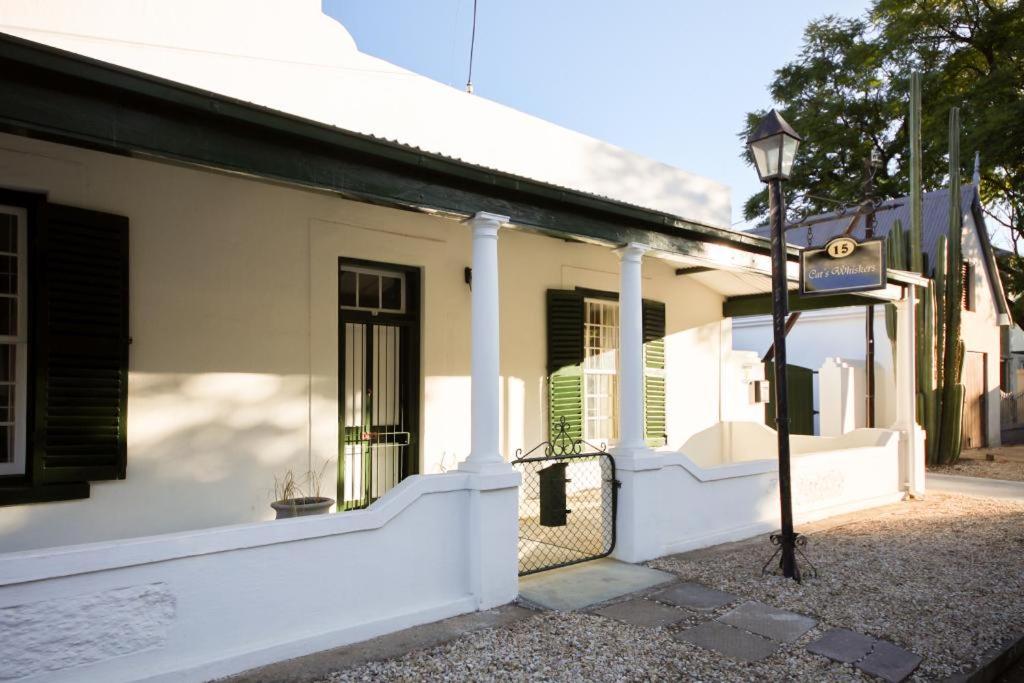 a white building with a street light in front of it at CatsWhiskers in Graaff-Reinet
