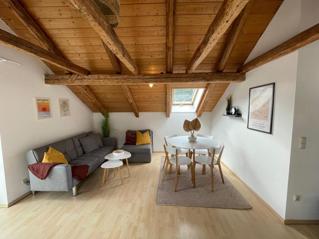 ein Wohnzimmer mit einem Sofa und einem Tisch in der Unterkunft BullsLiving Seeapartment 2 AM CORSO in Velden am Wörthersee