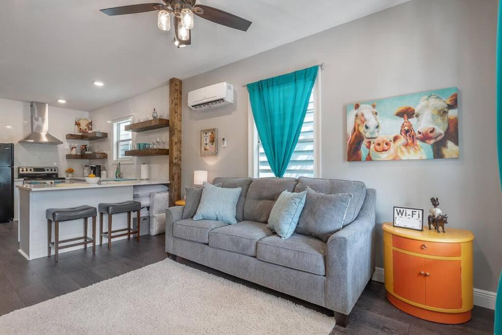 a living room with a couch and a kitchen at 2 Historic Ybor City Bungalows in the heart of Ybor City in Tampa