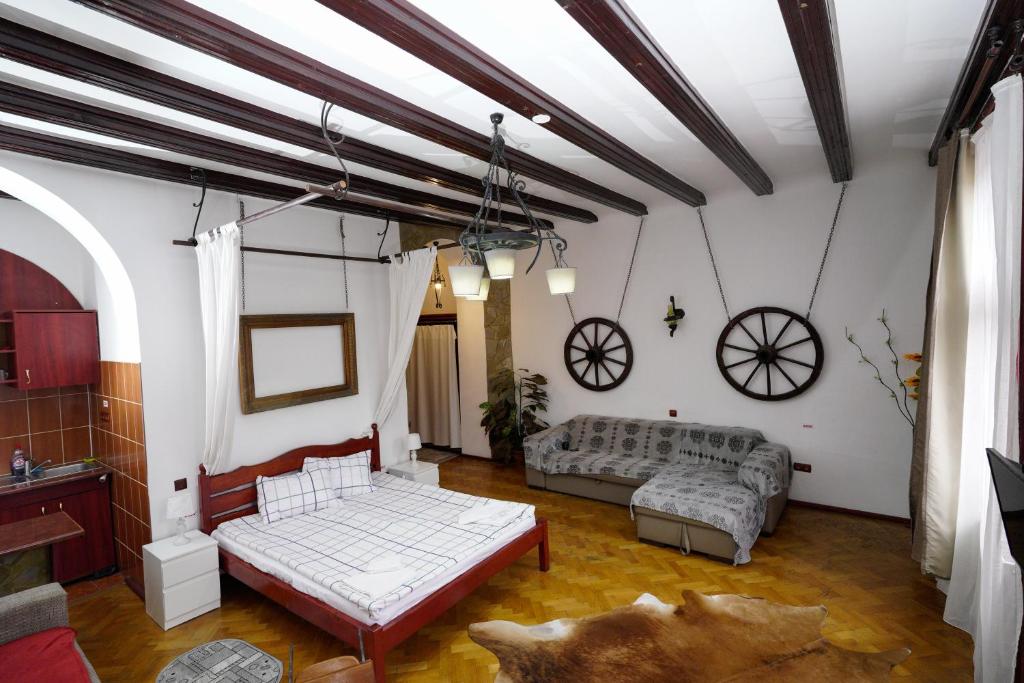 sala de estar con 2 camas y sofá en Pensiunea Noemi, en Brasov