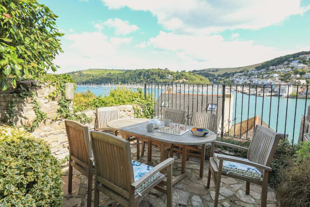 a table and chairs with a view of the water at 7 Nelson Steps in Dartmouth