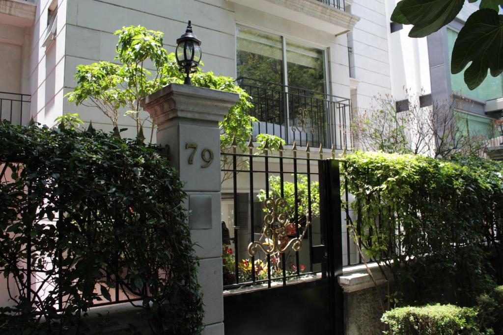 a house with a gate with a light on it at Residence L´ Heritage Tennyson by BlueBay in Mexico City