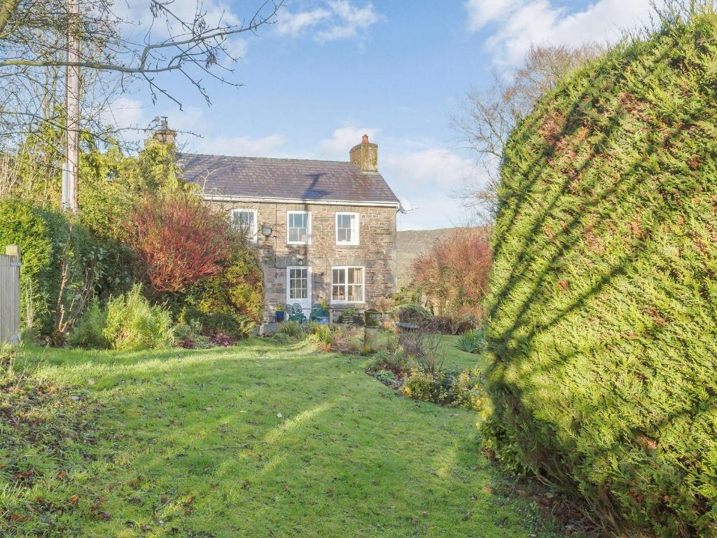 a large brick house with a yard in front of it at Pen Y Crug in Beulah