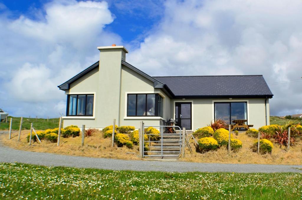 a small house on the side of a road at Cottage 103 - Claddaghduff in Cleggan