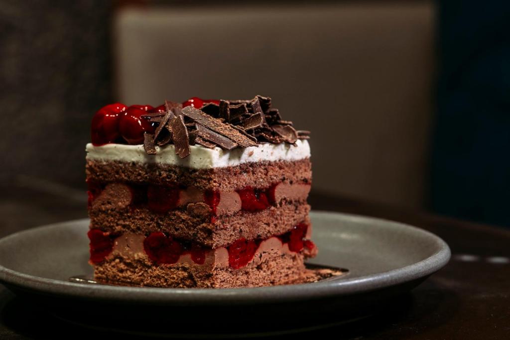 a piece of cake on a plate on a table at InterContinental Muscat by IHG in Muscat
