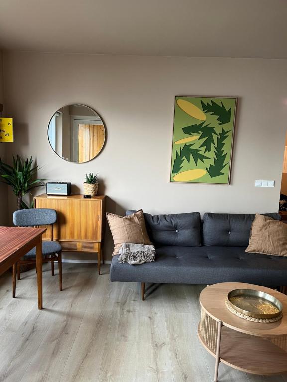 a living room with a blue couch and a table at Hidden Gem in Downtown Reykjavík in Reykjavík