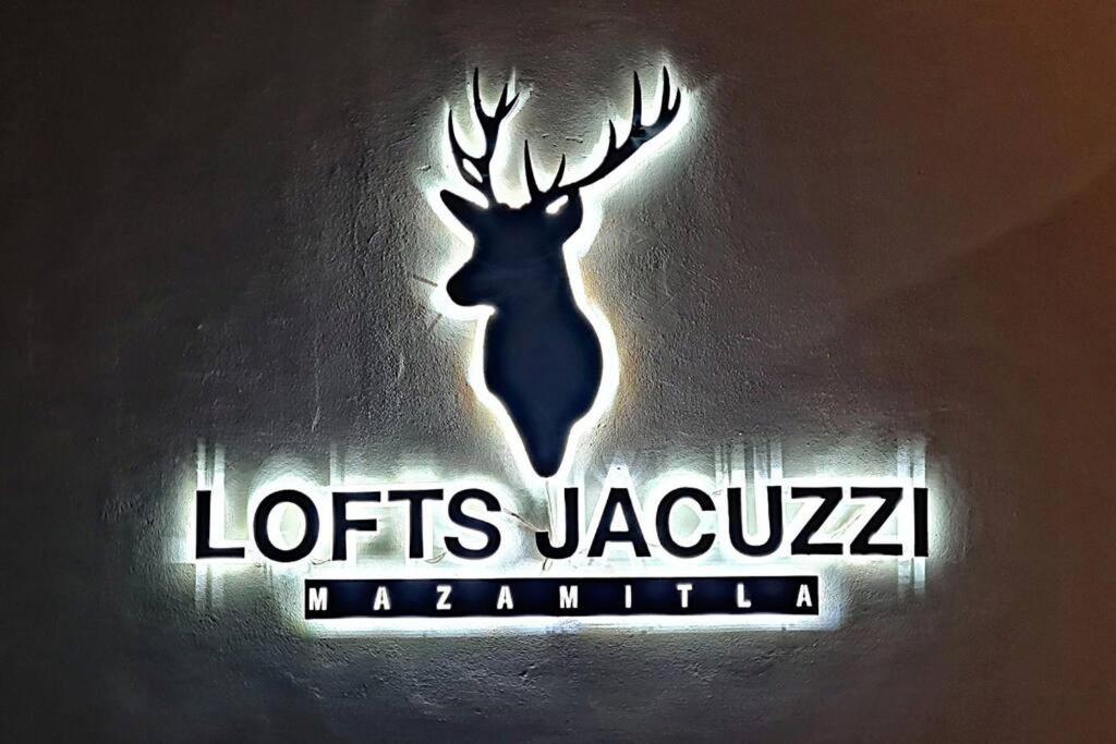 a sign with a deer on the side of a wall at No 1 Loft Jacuzzi Mazamitla in Mazamitla