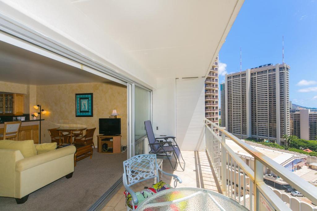 a living room with a view of a balcony at Ilikai Tower 1918 Lagoon View 1BR in Honolulu