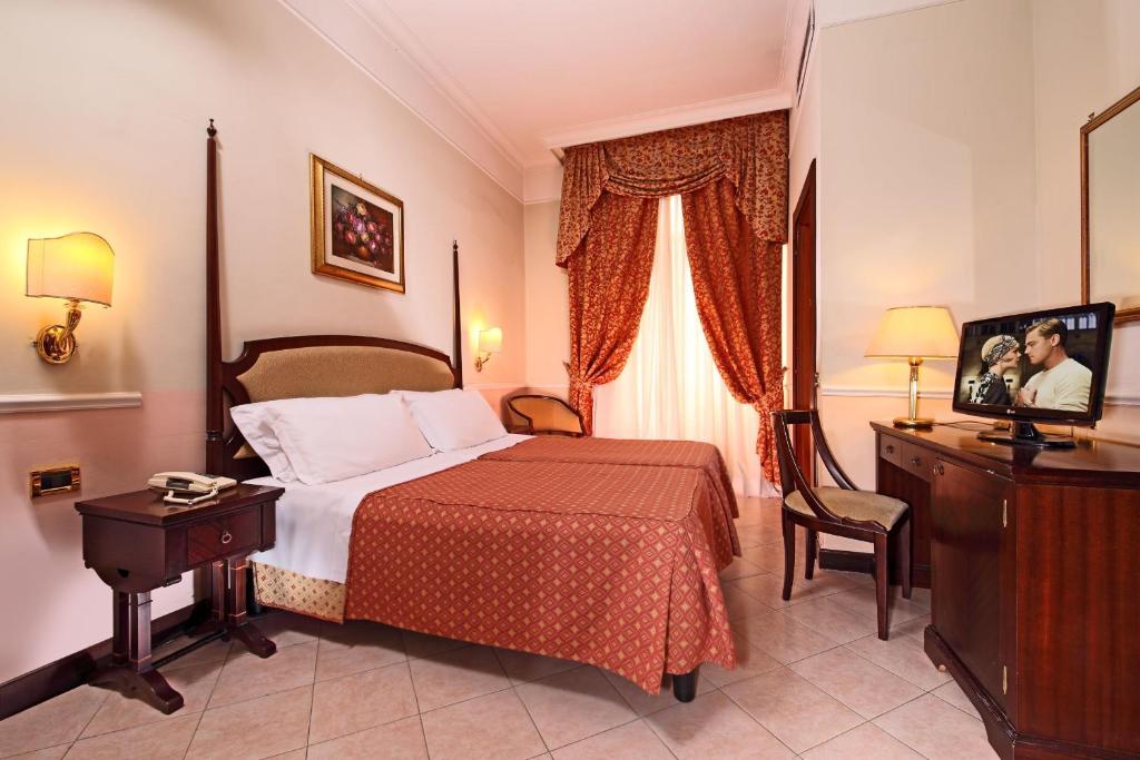 Postel nebo postele na pokoji v ubytování Hotel Nizza